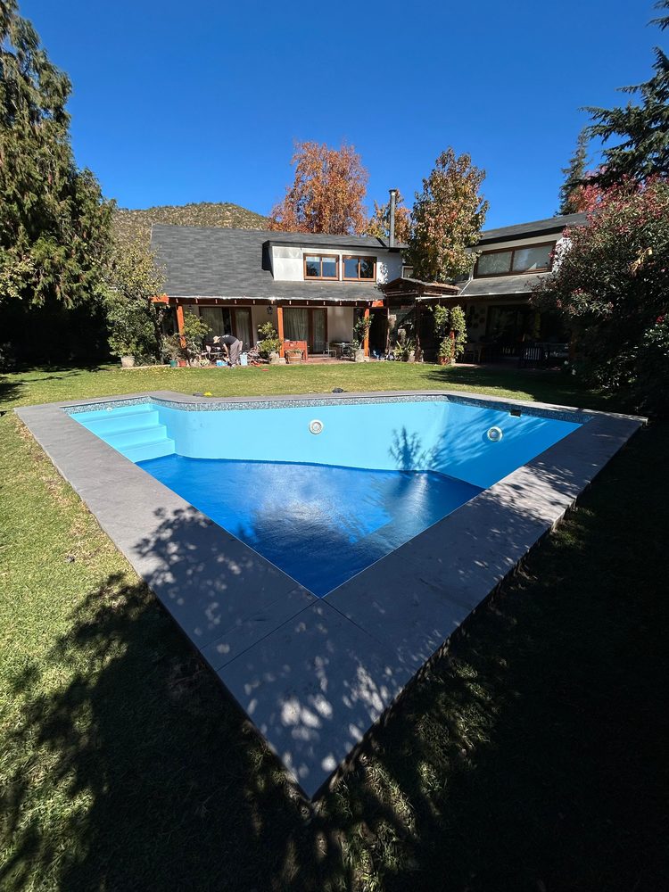 Piscina de diseño triangular terminada, con jardín